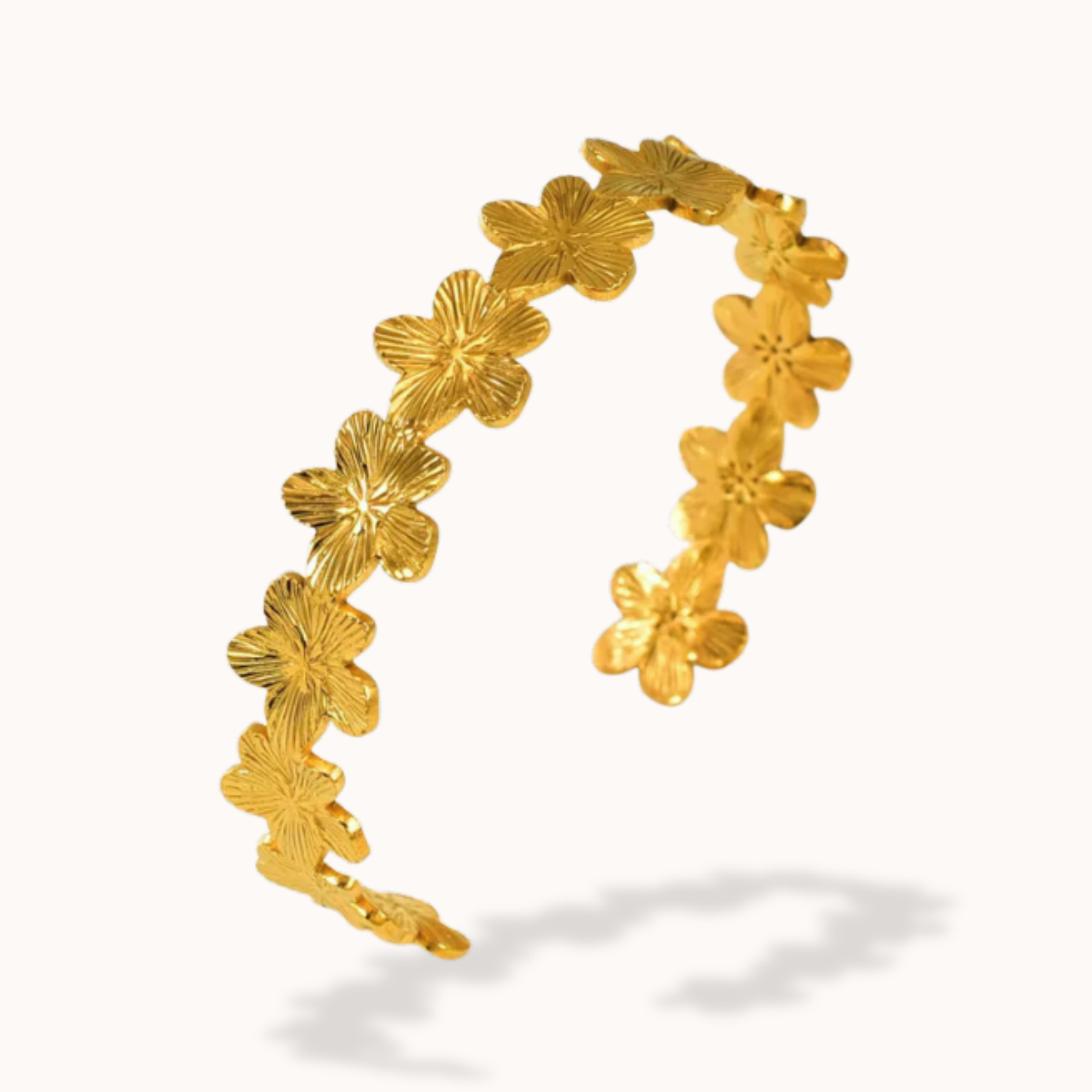 Gold floral hoop earrings on a white background