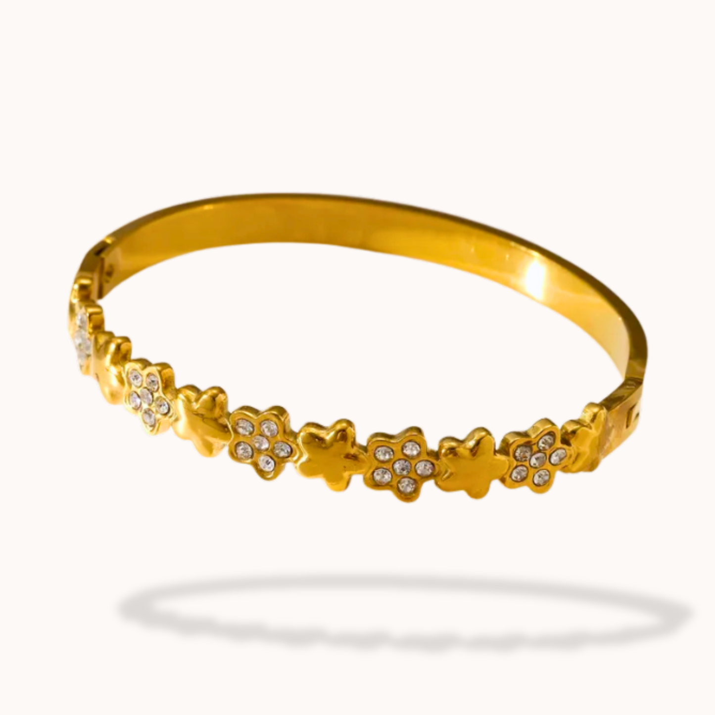 flower Gold bracelet with diamond accents on a white background