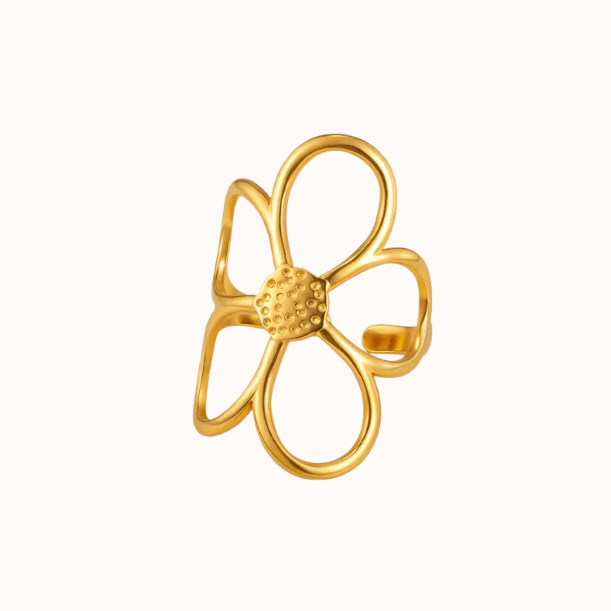 Gold flower-shaped ring on a white background