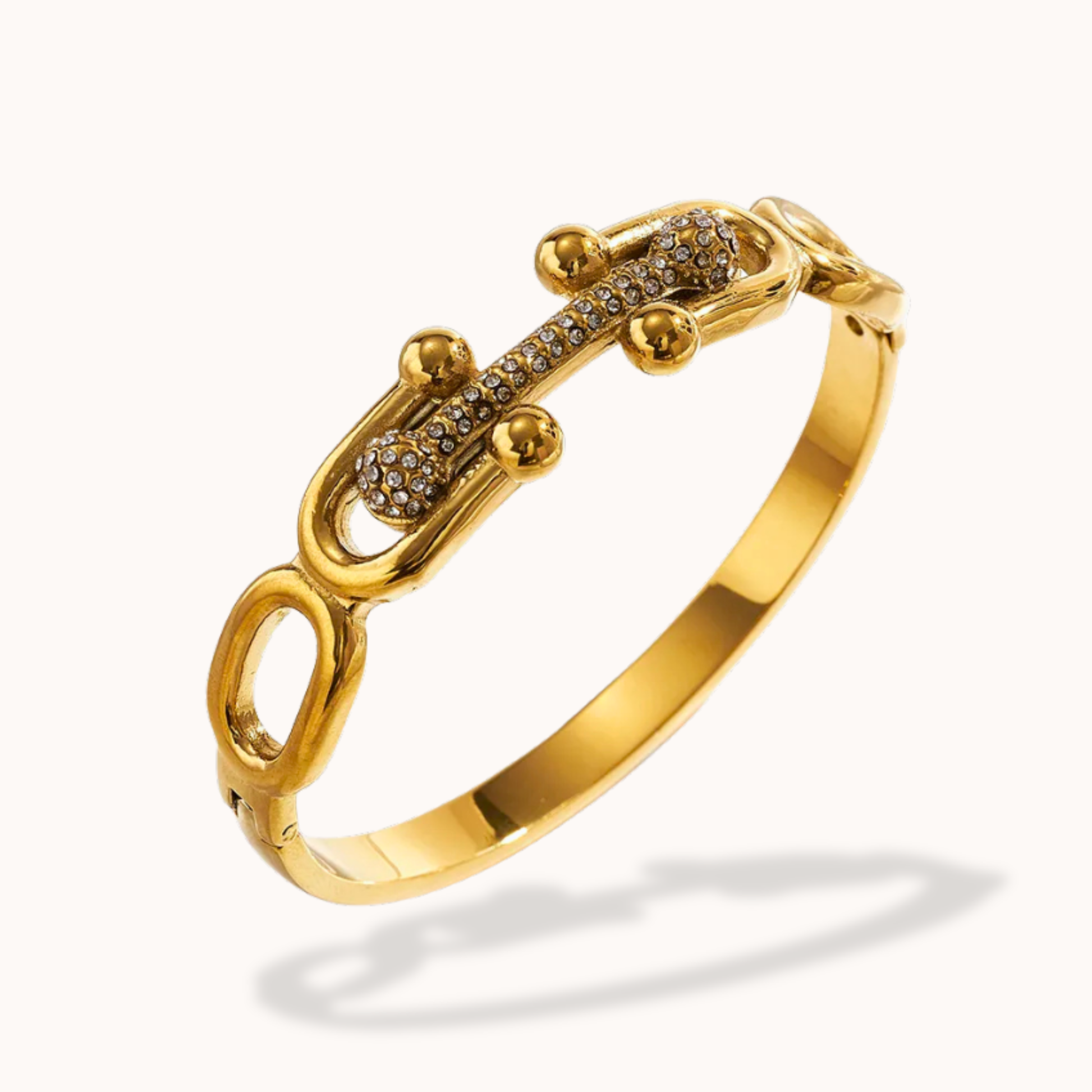 Gold bracelet with intricate design on a white background