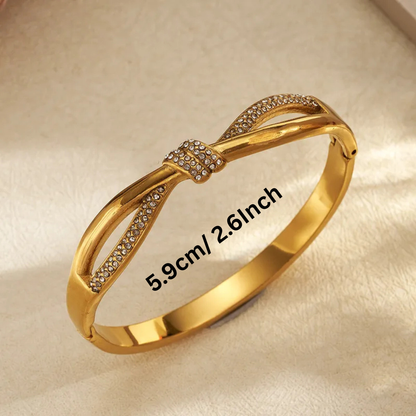 Gold bracelet with diamond accents on a beige background