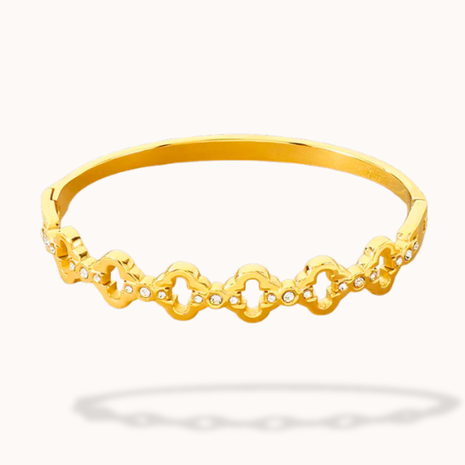 Gold bracelet with intricate design on a white background