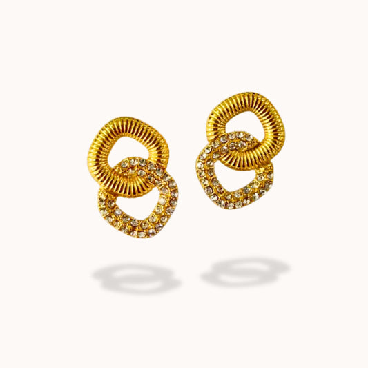 Gold earrings with interlocking rings on a white background