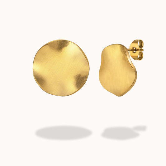Gold round  earrings on a white background
