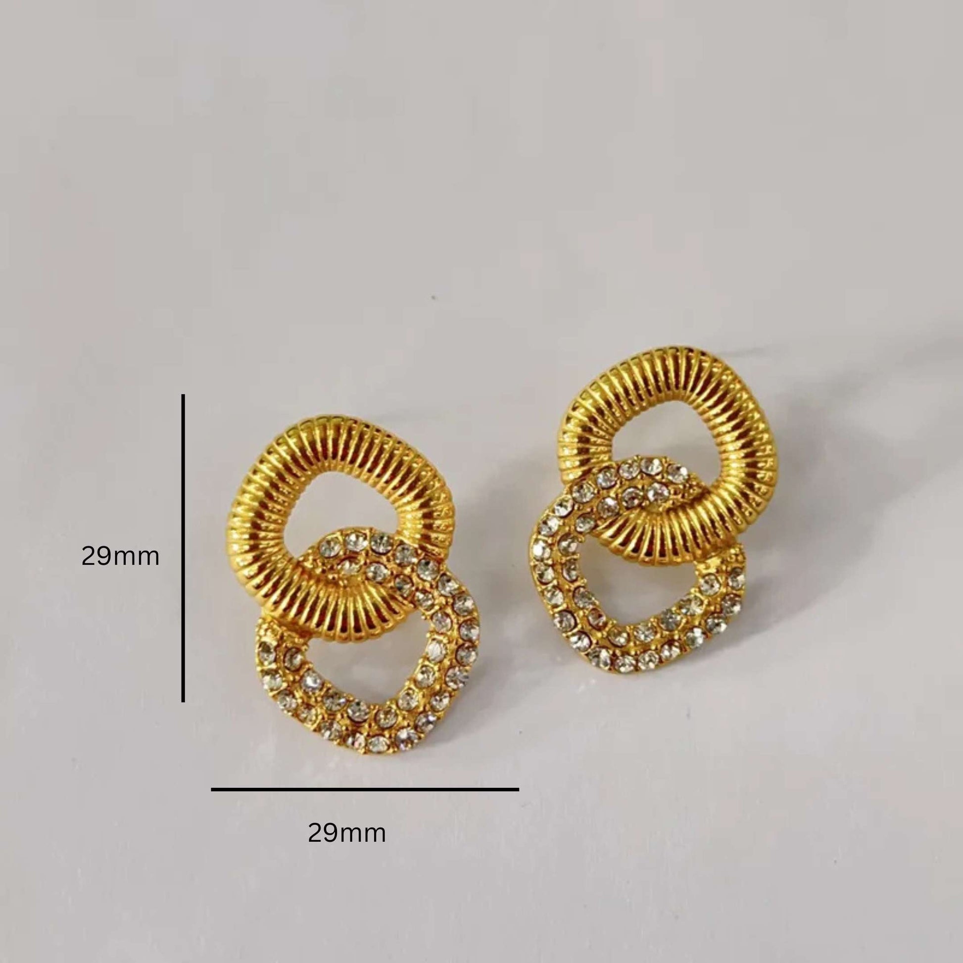 Gold earrings with square design on a light gray background with measurements