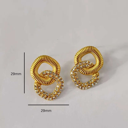 Gold earrings with square design on a light gray background with measurements