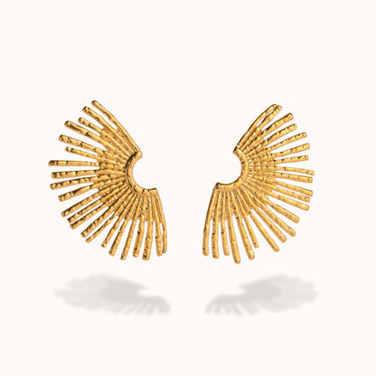 Gold fan-shaped earrings on a white background