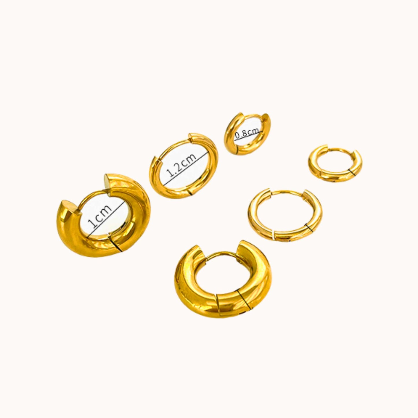 Set of gold hoop earrings with measurements on a white background