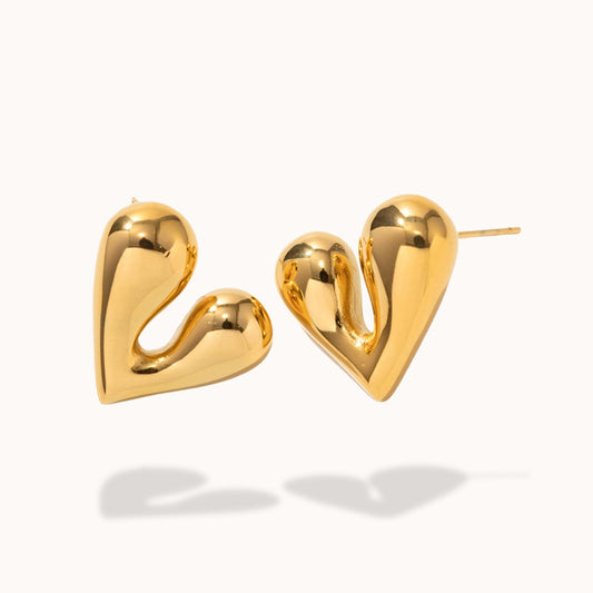 Gold heart-shaped earrings on a white background