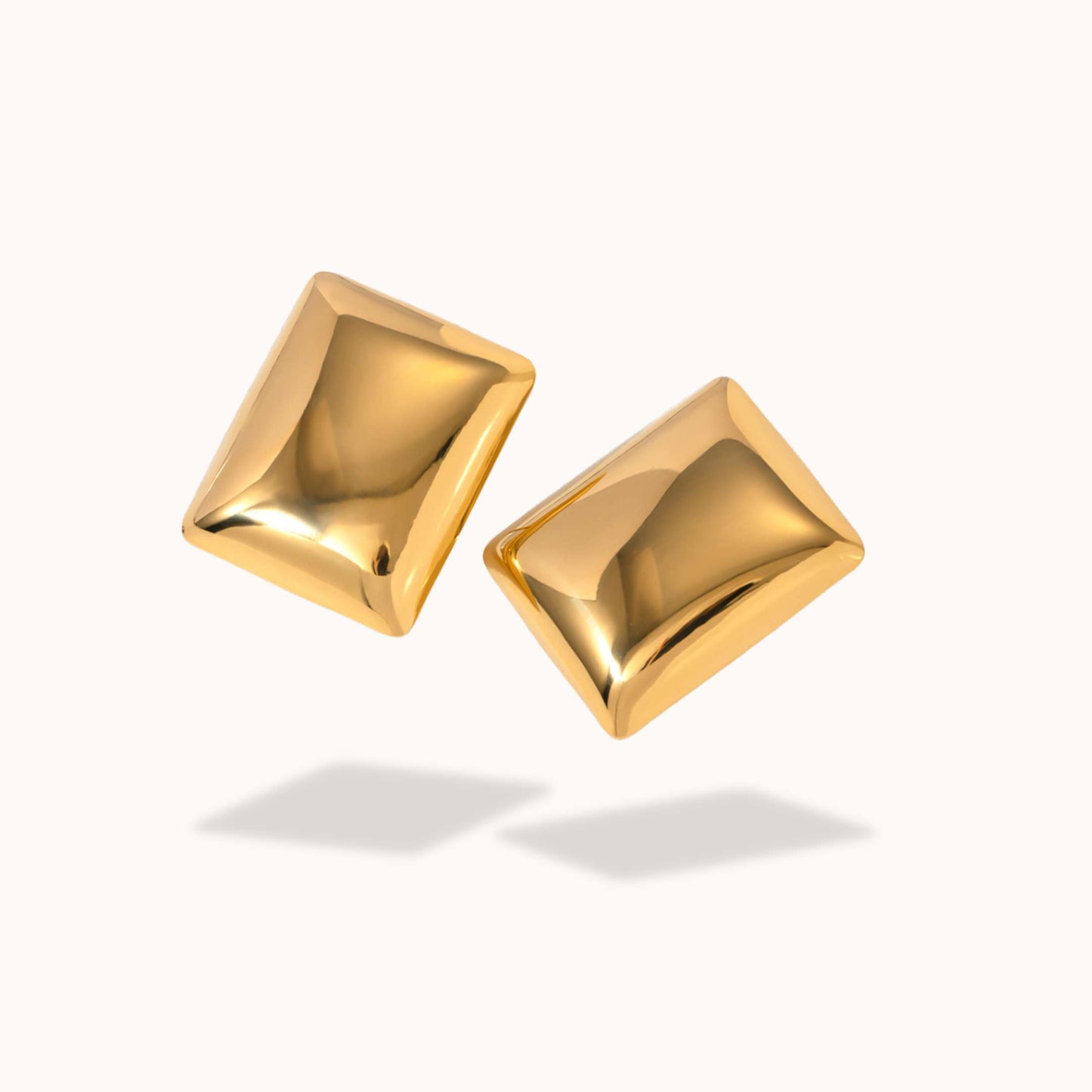 Pair of gold square earrings on a white background
