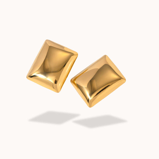 Pair of gold square earrings on a white background