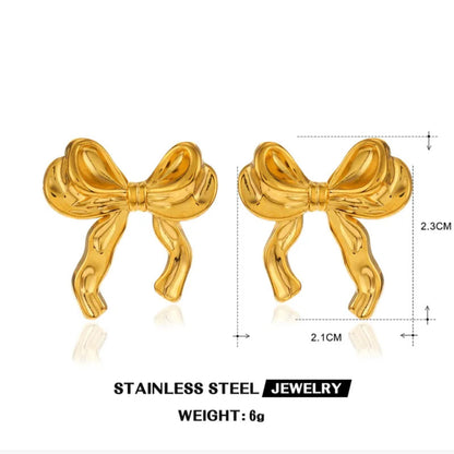 Gold bow-shaped earrings with measurements on a white background