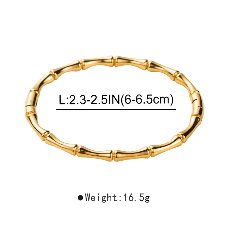 Gold bracelet with measurements on a white background
