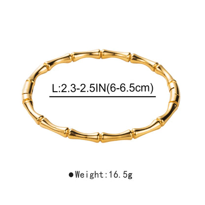 Gold bracelet with measurements on a white background