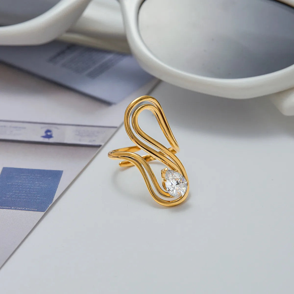Gold ring with a diamond on a light surface