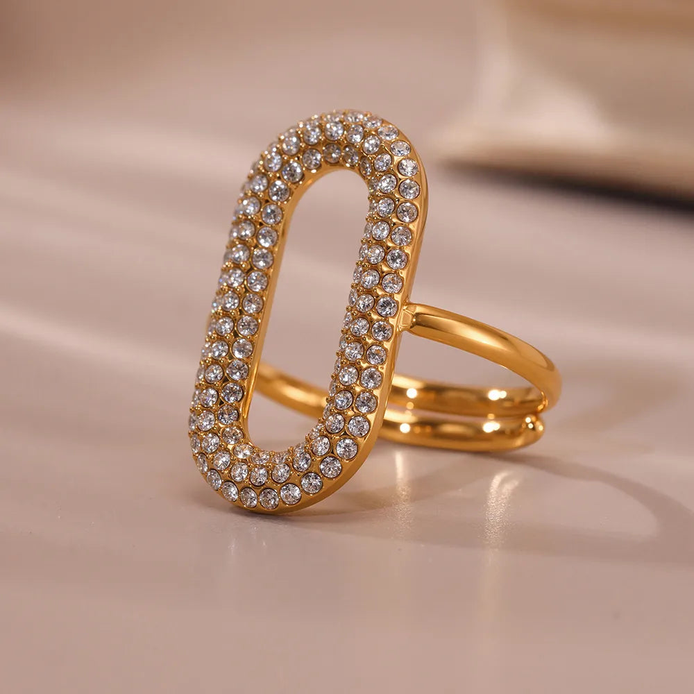 Gold ring with diamond accents on a beige background
