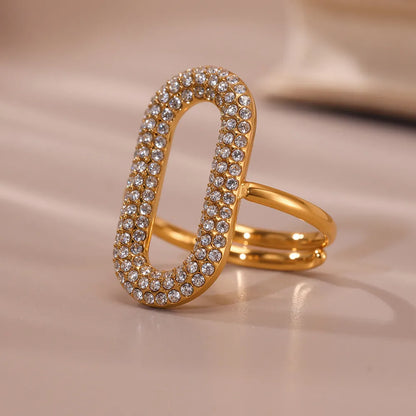 Gold ring with diamond accents on a beige background