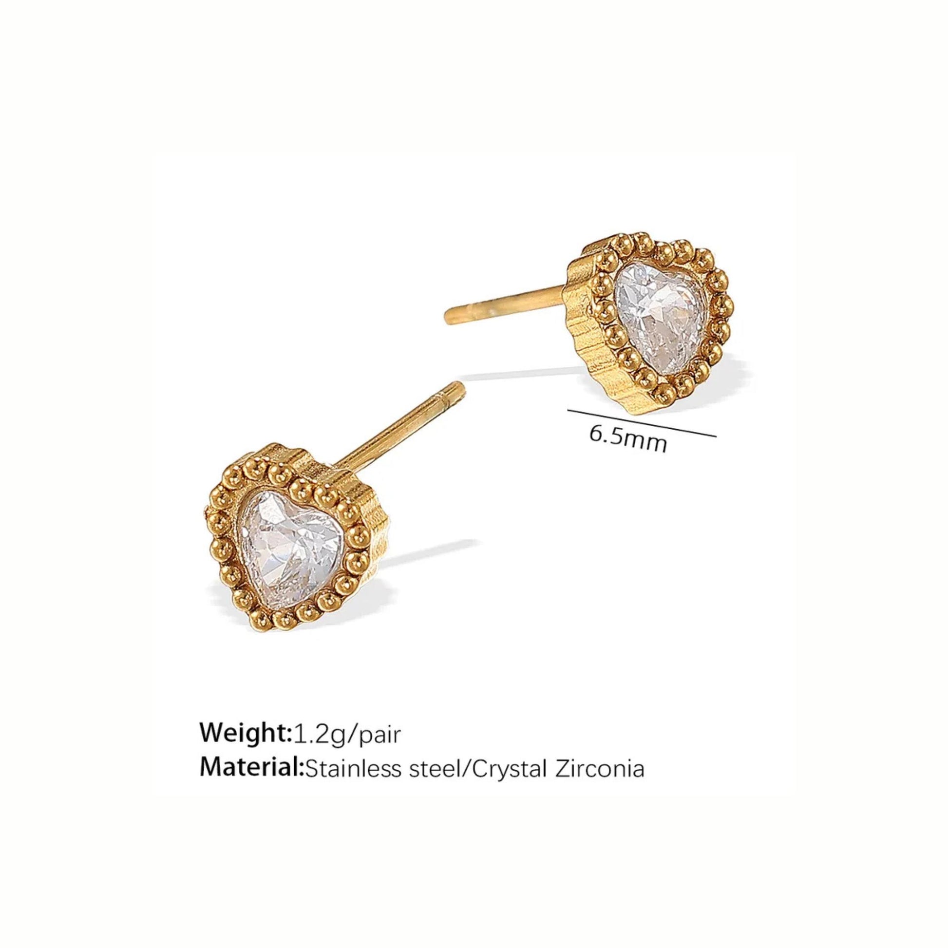 Gold heart-shaped earrings with clear stones on a white background