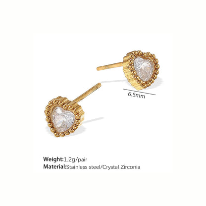 Gold heart-shaped earrings with clear stones on a white background