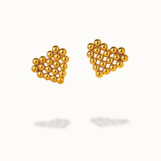 Gold heart-shaped beaded earrings on a white background
