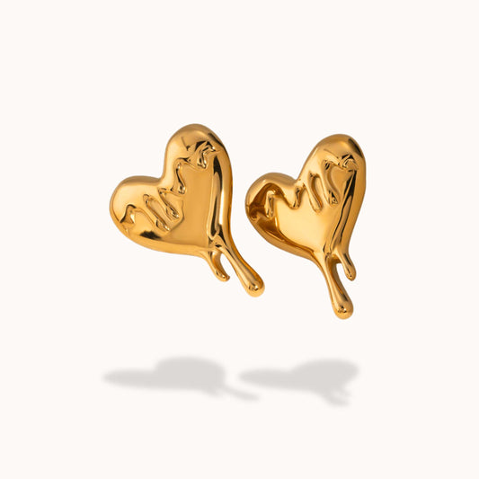 Gold drip heart-shaped earrings on a white background