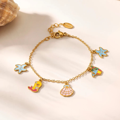 Gold bracelet with colorful charms on a light background