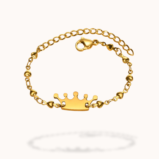 Gold bracelet with a crown charm on a white background