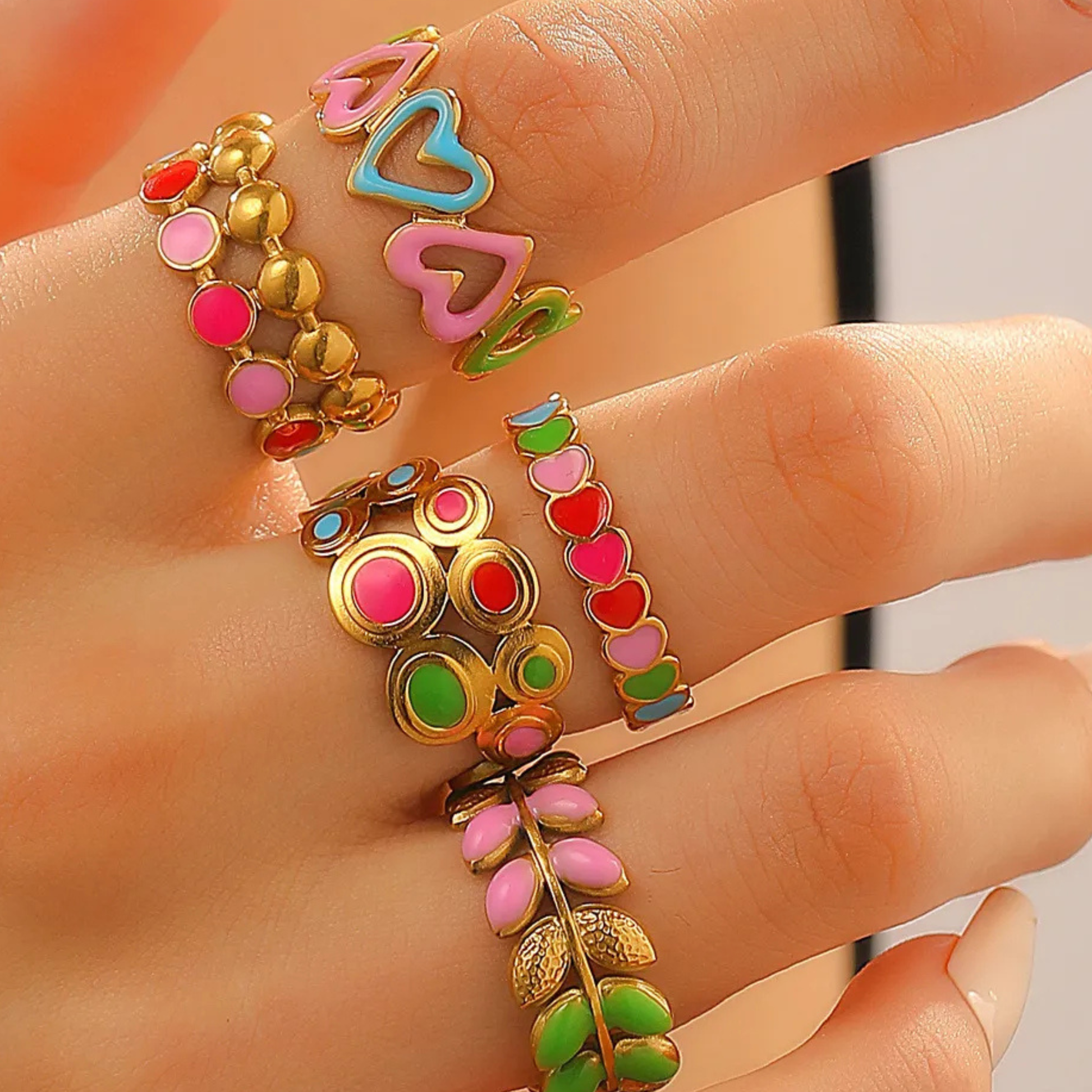 Colorful bracelets on a person's wrist with a neutral background