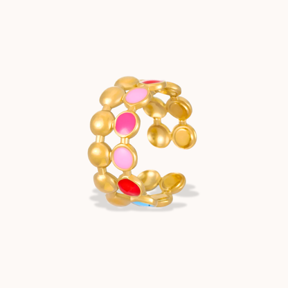 Gold ring with colorful beads on a white background