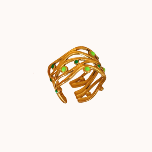 Gold ring with green enamel on a white background