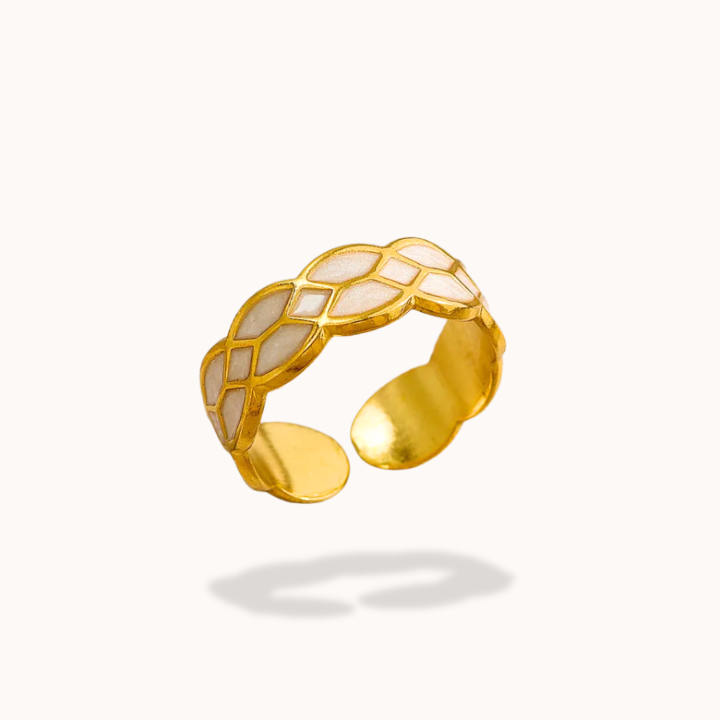 Gold ring with white pattern on a white background