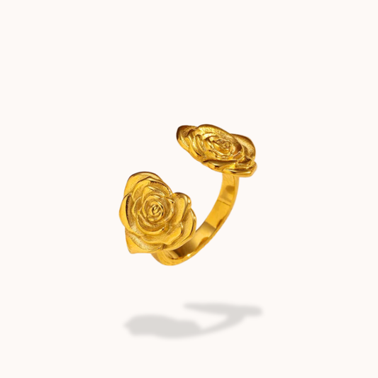 Gold rose-shaped ring on a white background