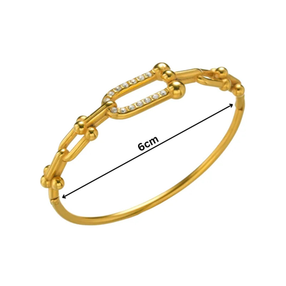 Gold bracelet with measurement on a white background