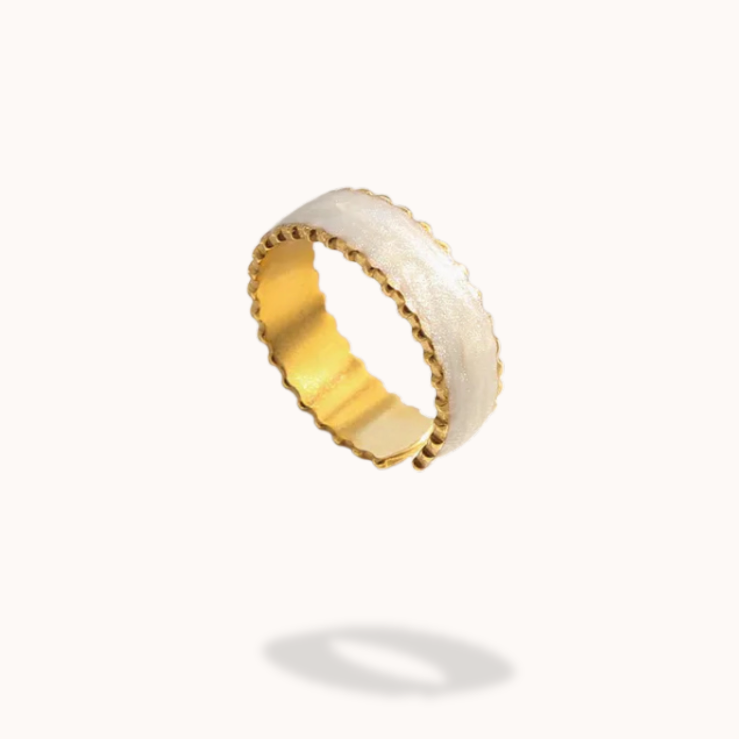 Gold and white ring on a white background
