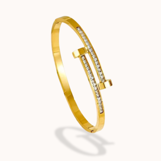 Gold bracelet with diamond accents on a white background
