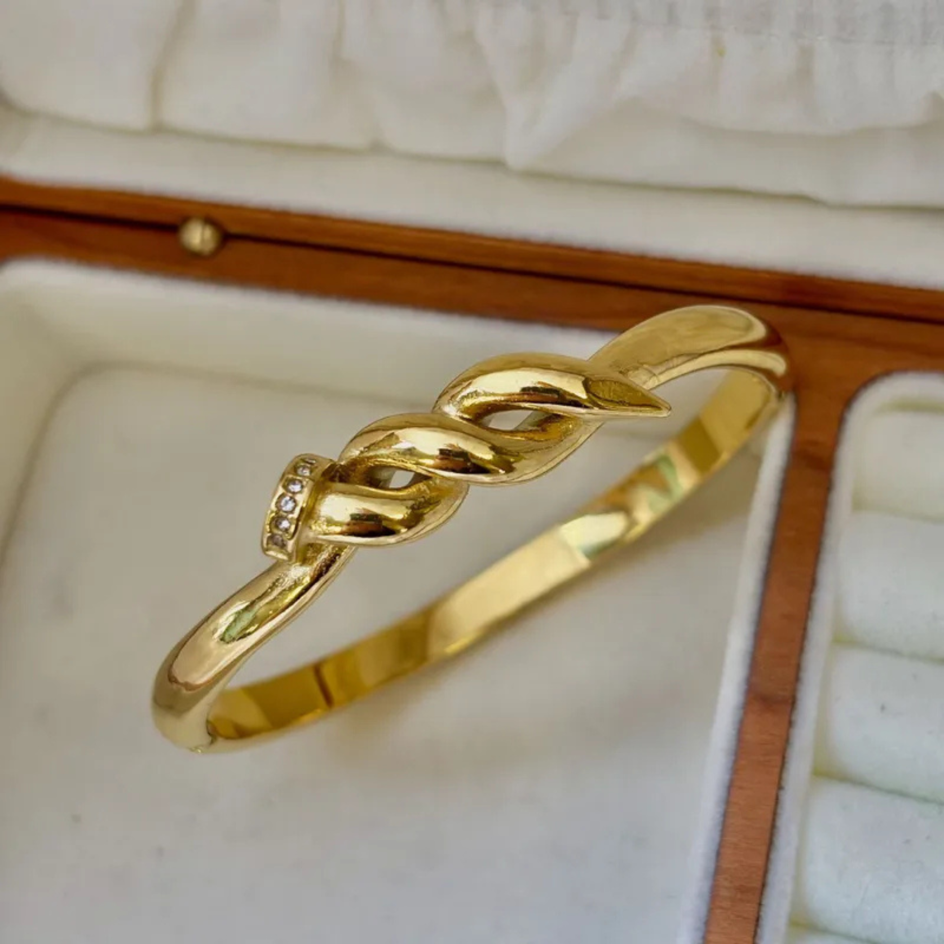 Gold bracelet with a diamond in an open jewelry box