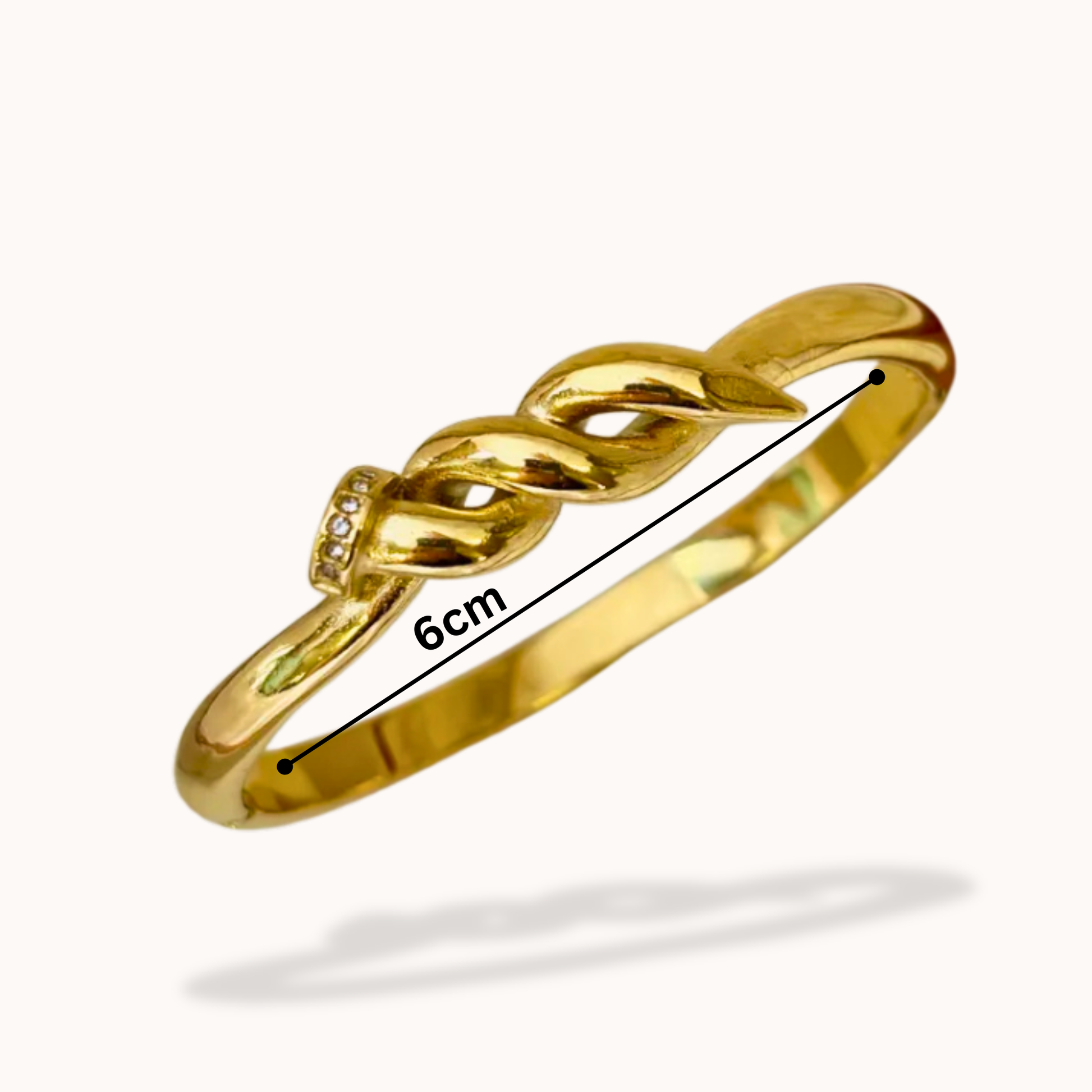 Gold bracelet with measurement label on a white background