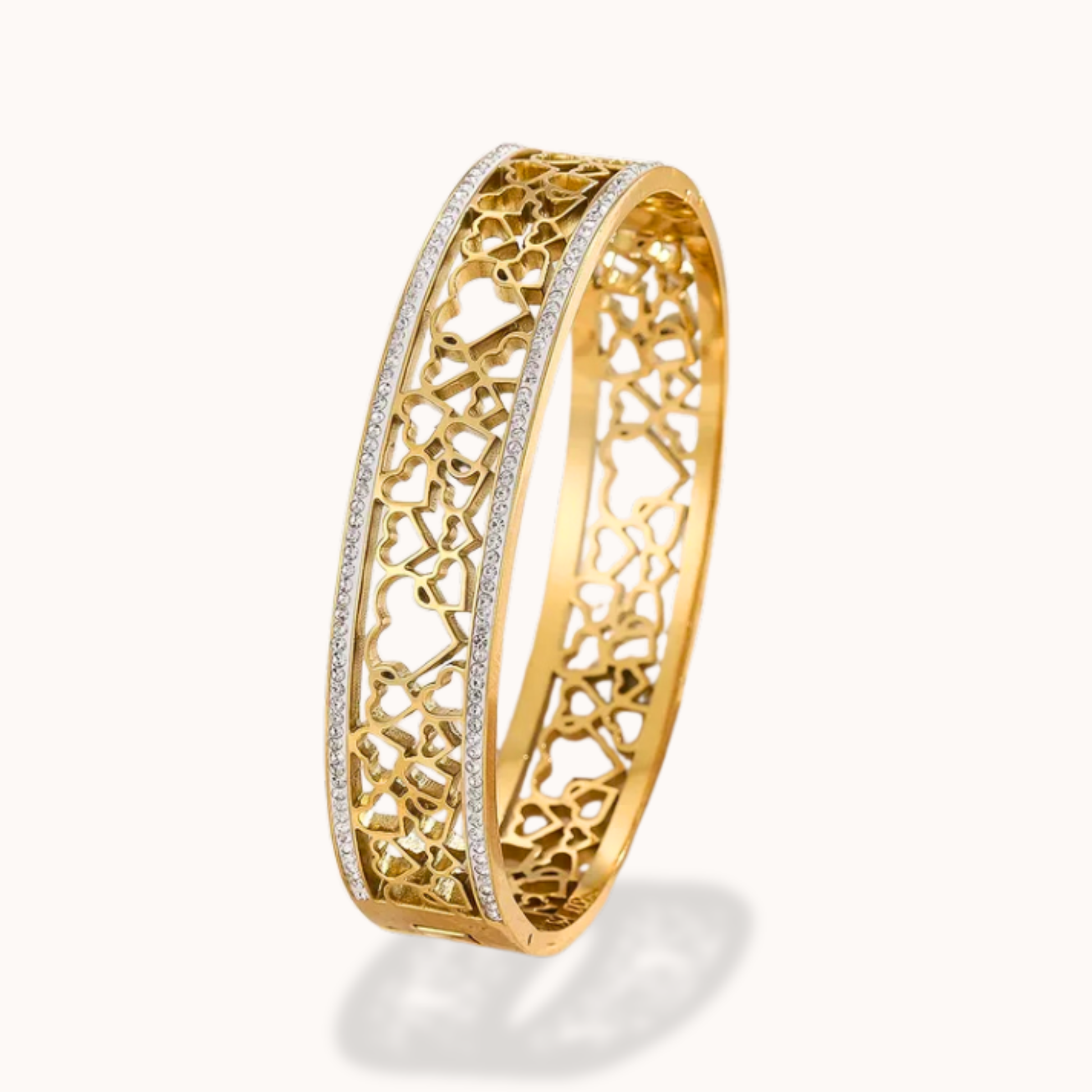 Gold bracelet with intricate design on a white background
