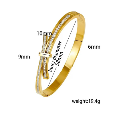 Gold bracelet with measurements on a white background