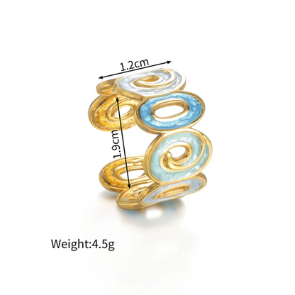 Gold and blue ring with measurements and weight on a white background