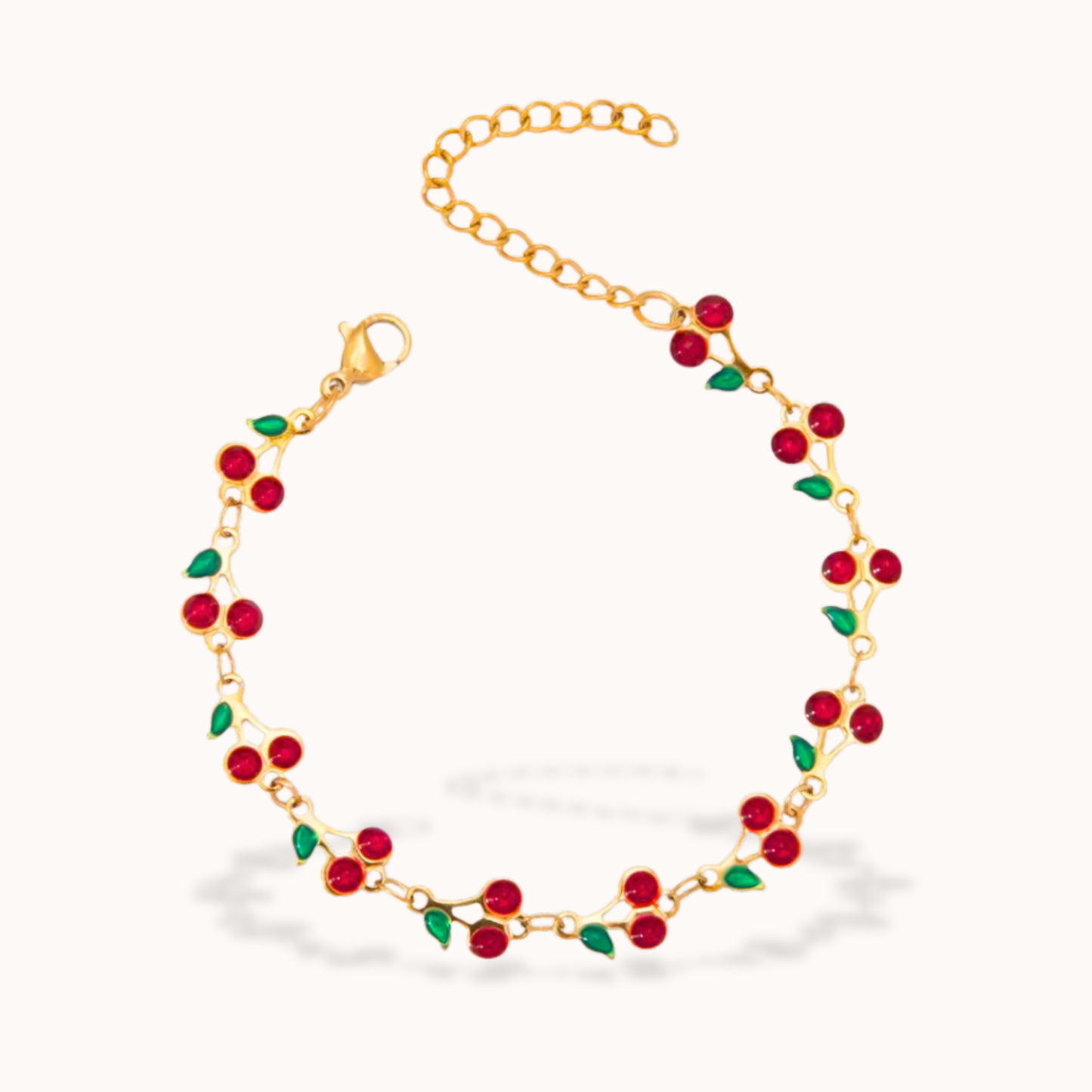 Gold bracelet with red cherry Enamel on a white background