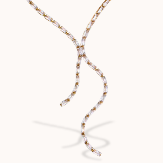 Beaded necklace with gold and clear beads on a white background