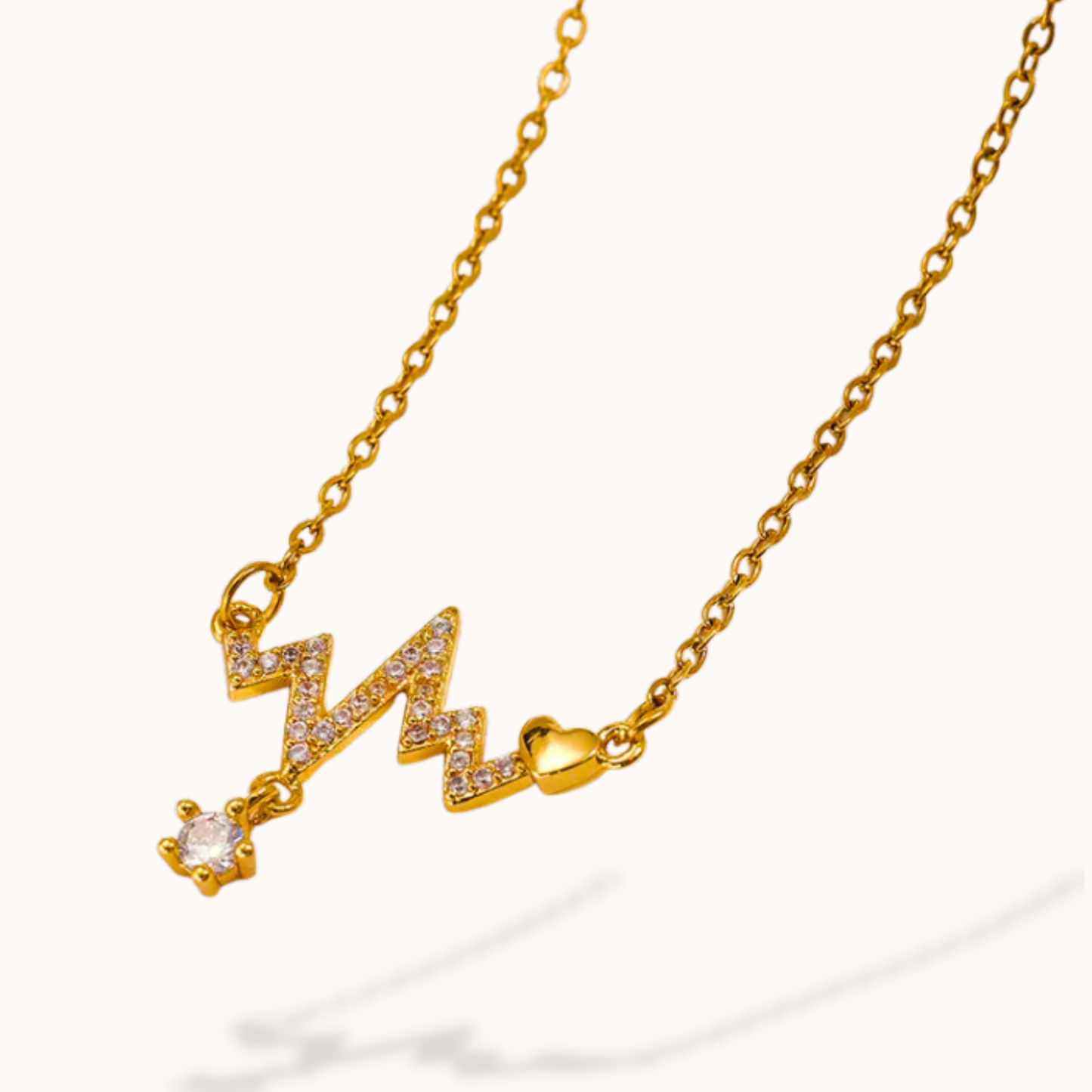 Gold necklace with a unique pendant design on a white background