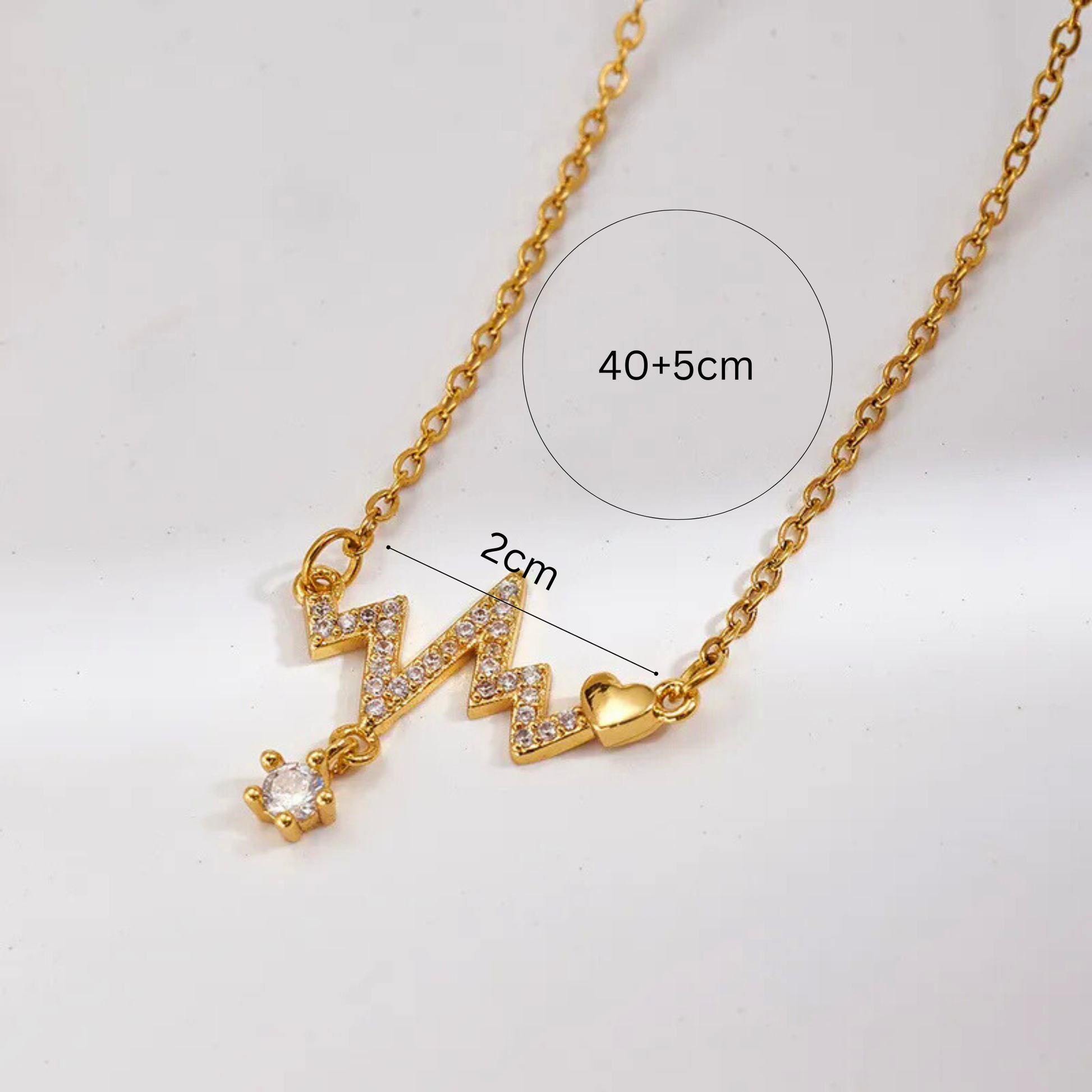 Gold necklace with heart beat pendant on a white background