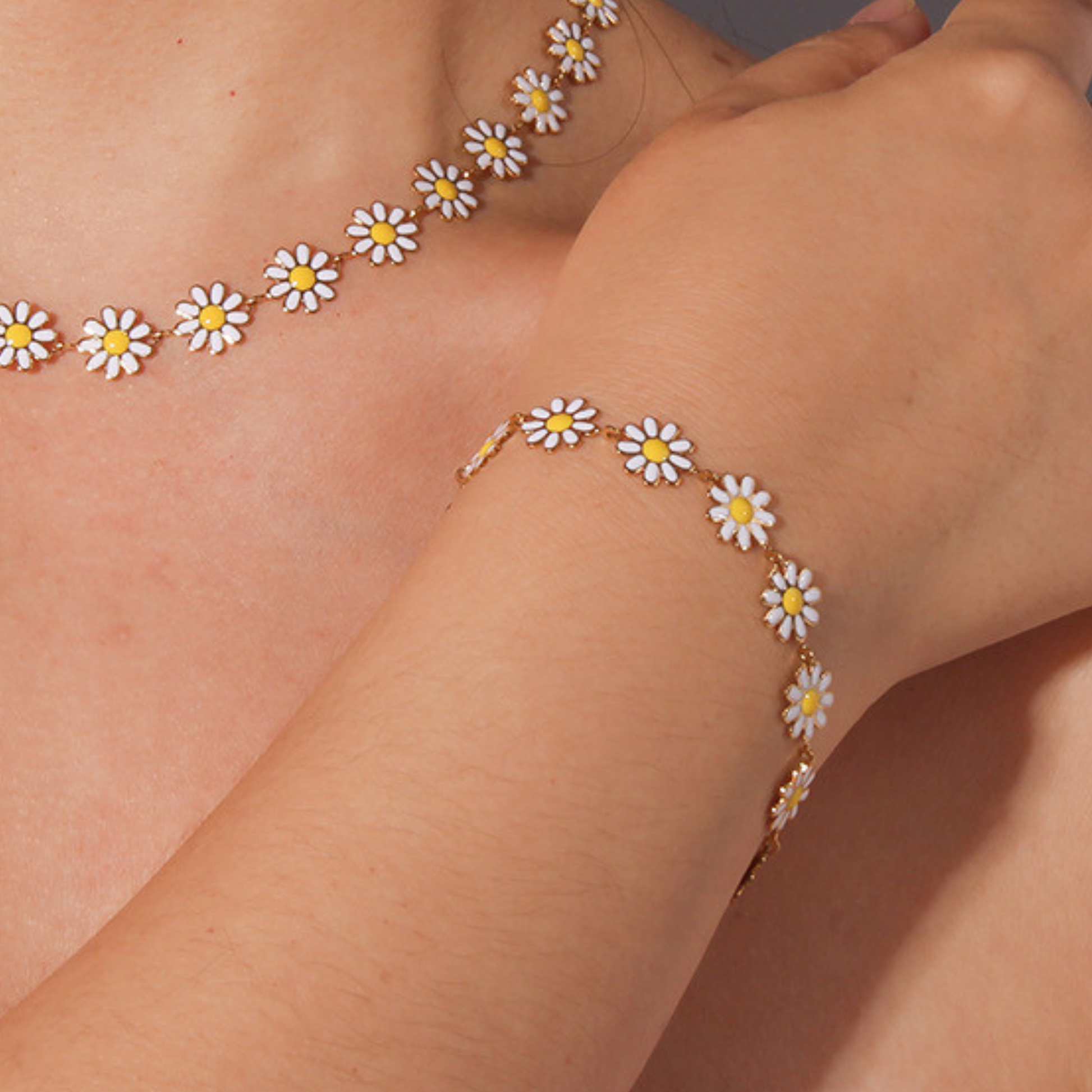 Daisy chain bracelet on a wrist with a neutral background