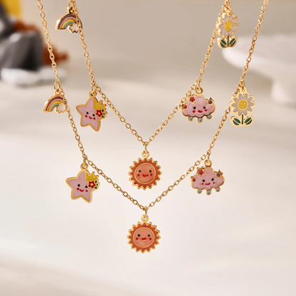 Gold necklaces with colorful charms on a light background