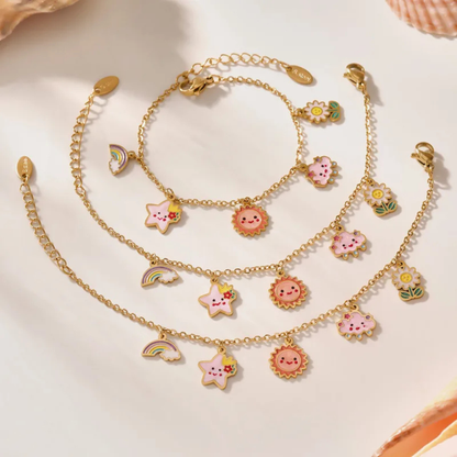 Set of gold necklaces with colorful charms on a light background