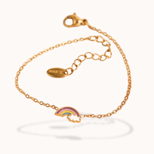 Gold bracelet with a rainbow charm on a white background