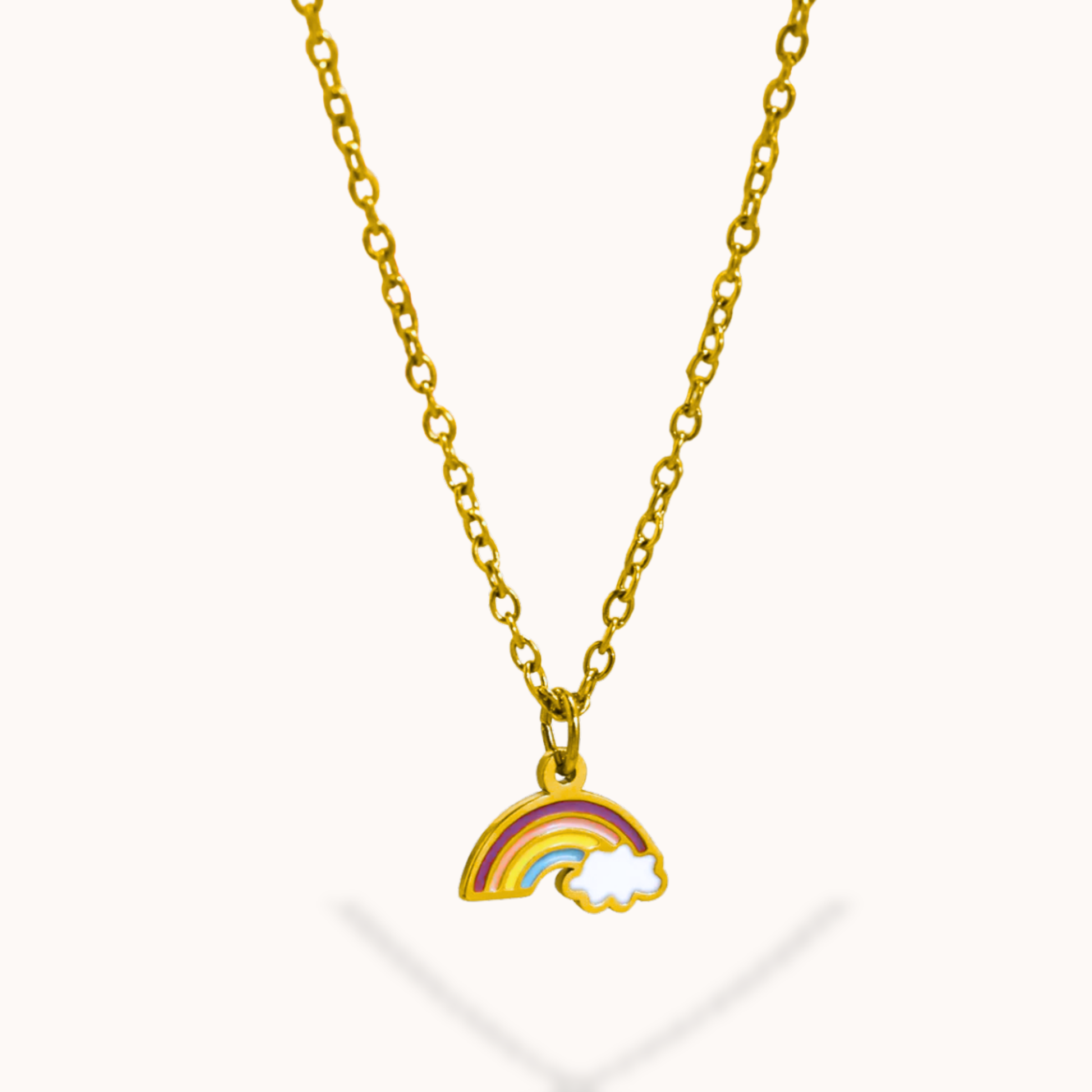 Gold necklace with a rainbow and cloud pendant on a white background