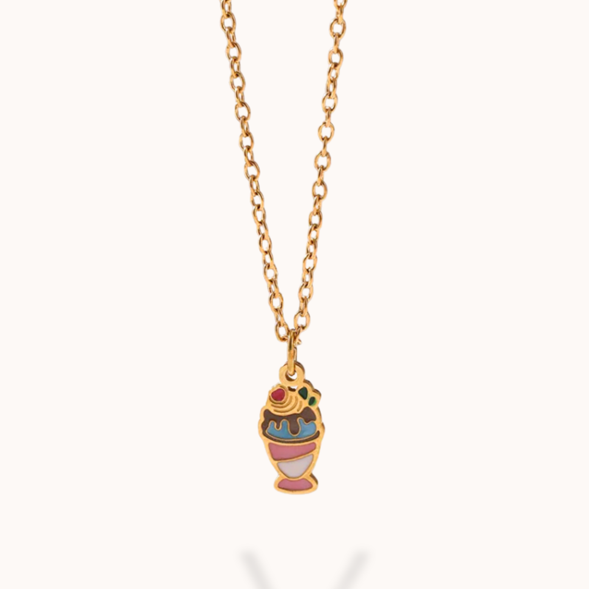 Necklace with a colorful ice cream cone pendant on a gold chain against a white background